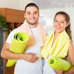 Man and woman with yoga mats