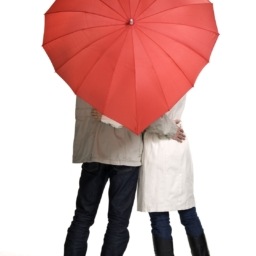 Couple under heart-shaped umbrella